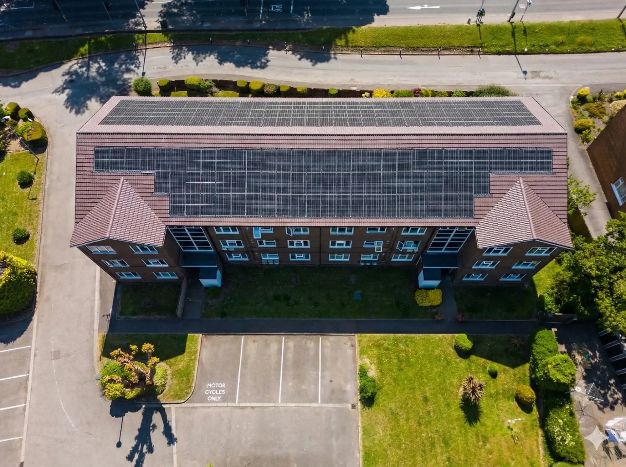 A single rooftop solar PV system on a modern UK residential development, enabled by Allume SolShare to provide clean energy to all residents and improve EPC ratings.